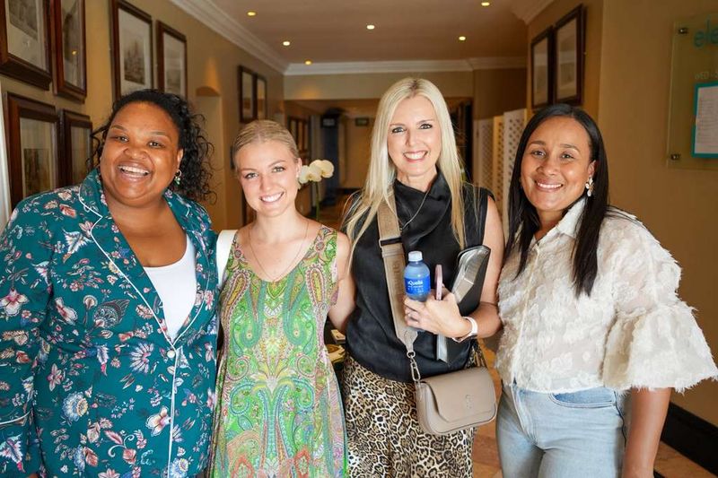 Four smiling women enjoying fellowship between sessions