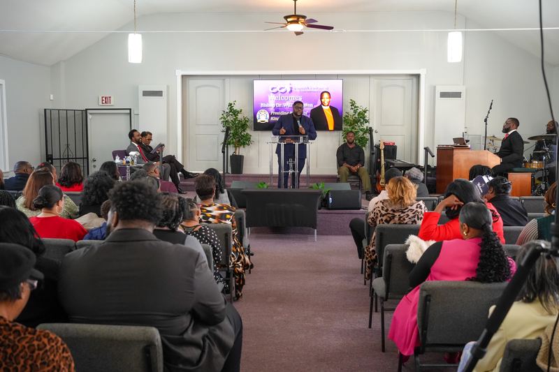 A full sanctuary listening as a minister preaches from the pulpit